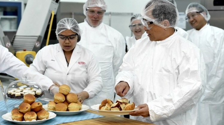 DuPont executives inspect the Singapore ingredients lab with chief science officer Douglas Muzyka (second left) in tow.