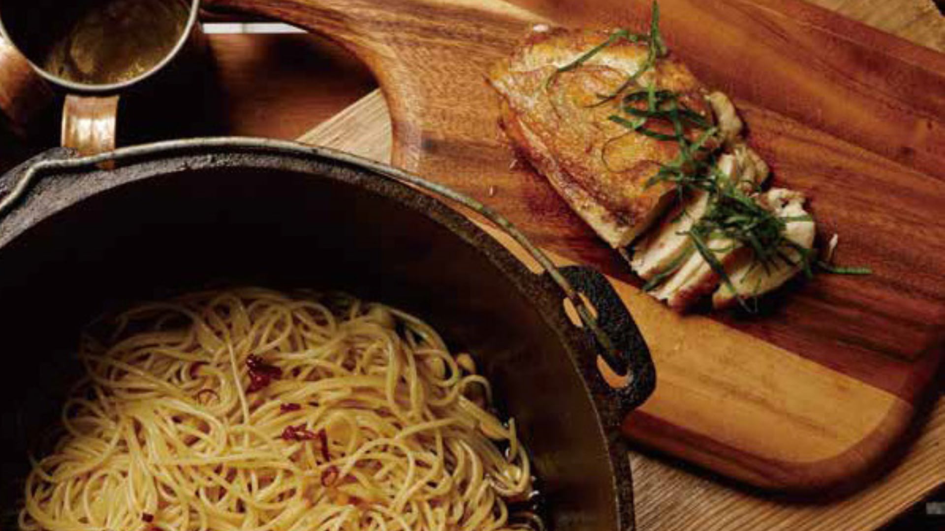 Ginger syrup used as a marinade in a chicken pasta dish, highlighting its versatility beyond beverages.