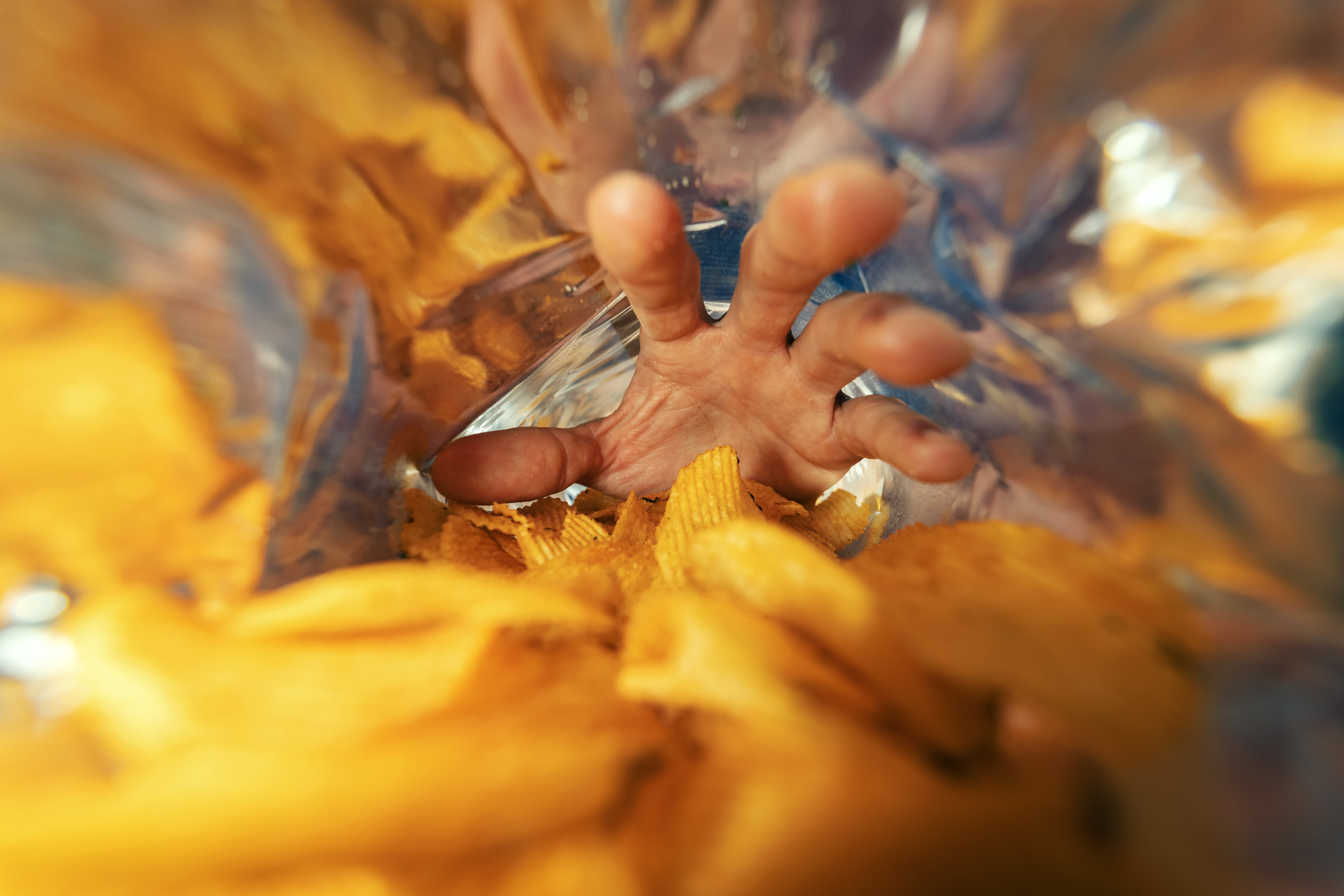 Hand grabbing for potato crisps