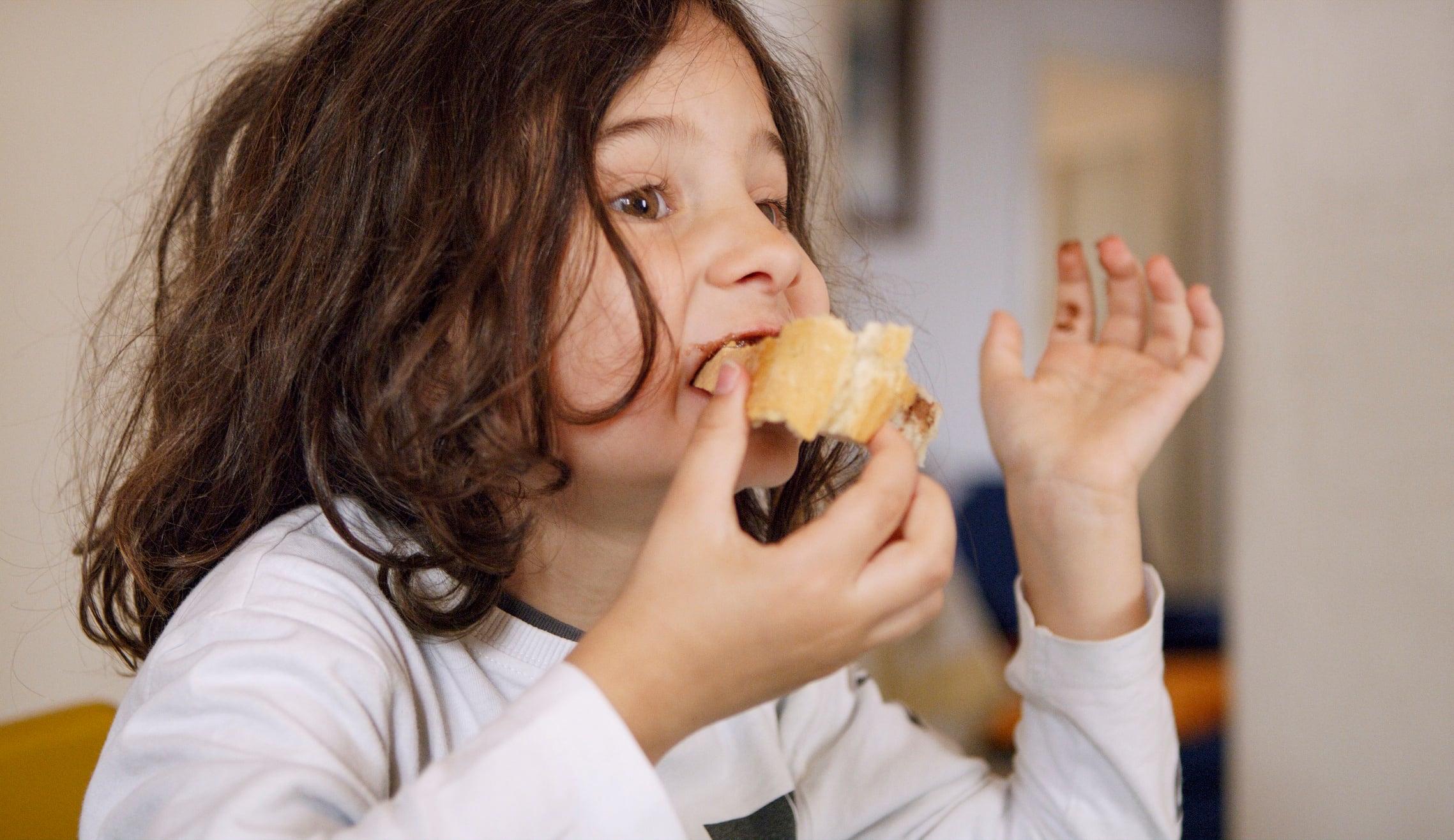 Little girl eating bread
