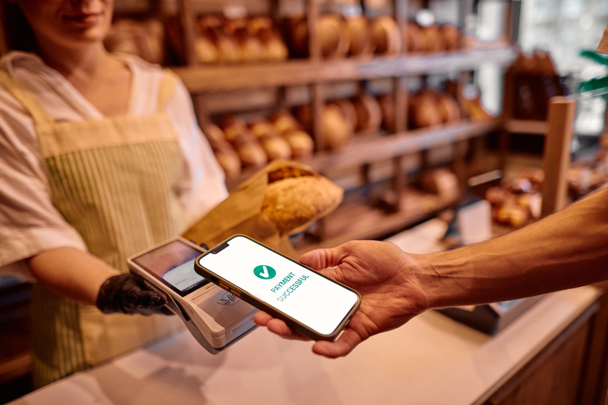 Customer paying with smartphone in bakery