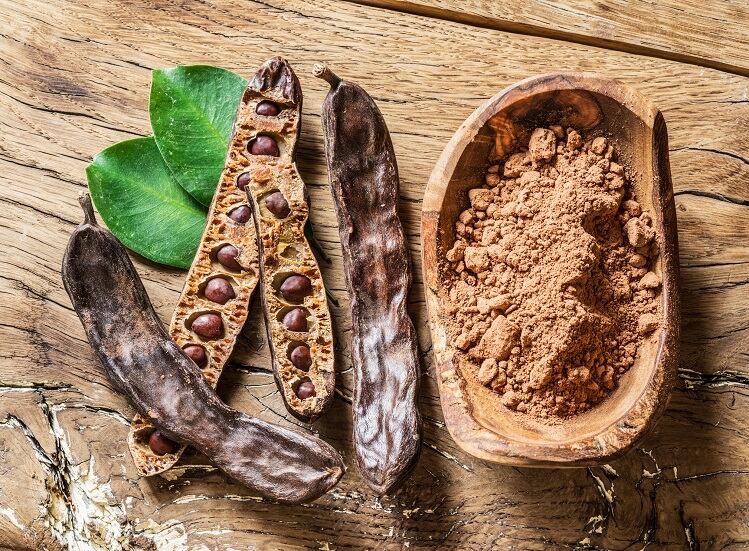 Carob-pods-and-powder-Valentyn-Volkov-polyphenol-GettyImages-925193380.jpg