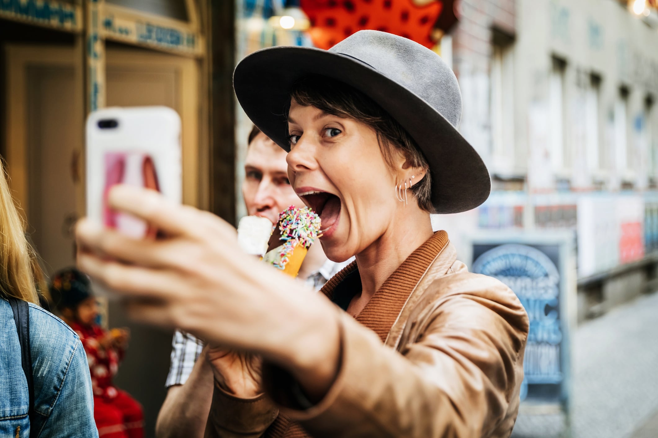 Woman posting a selfie while snacking