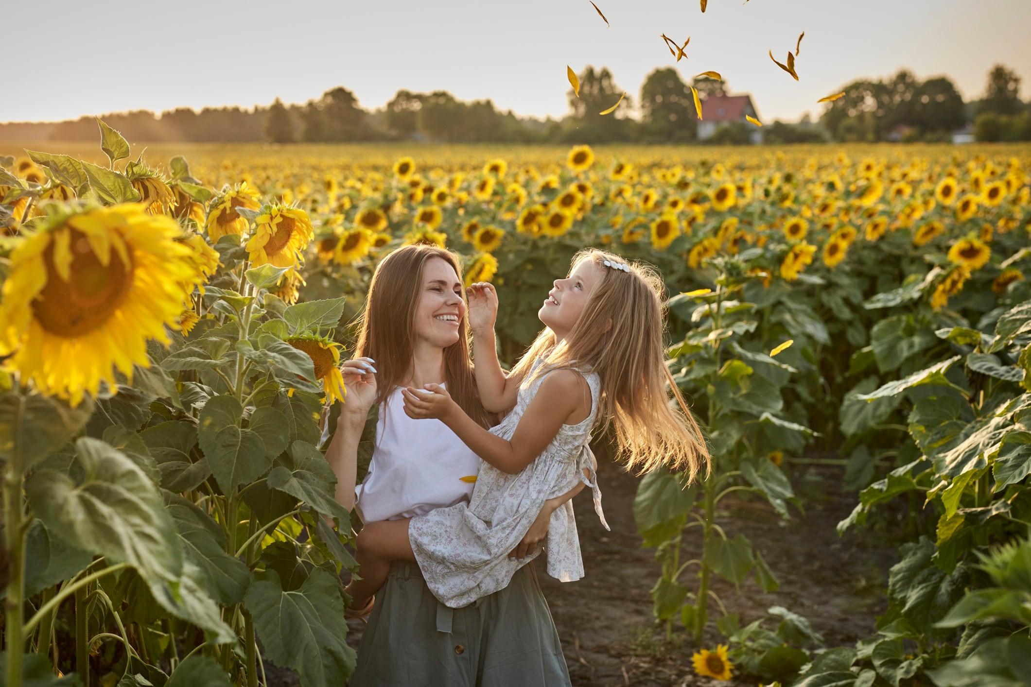 Mother and daughter in sunflower field