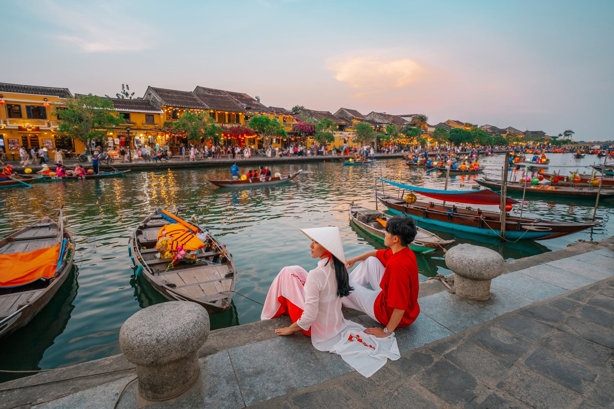 Couple wearing Vietnam  traditional culture walking around at Hoi An ancient town in Vietnam.