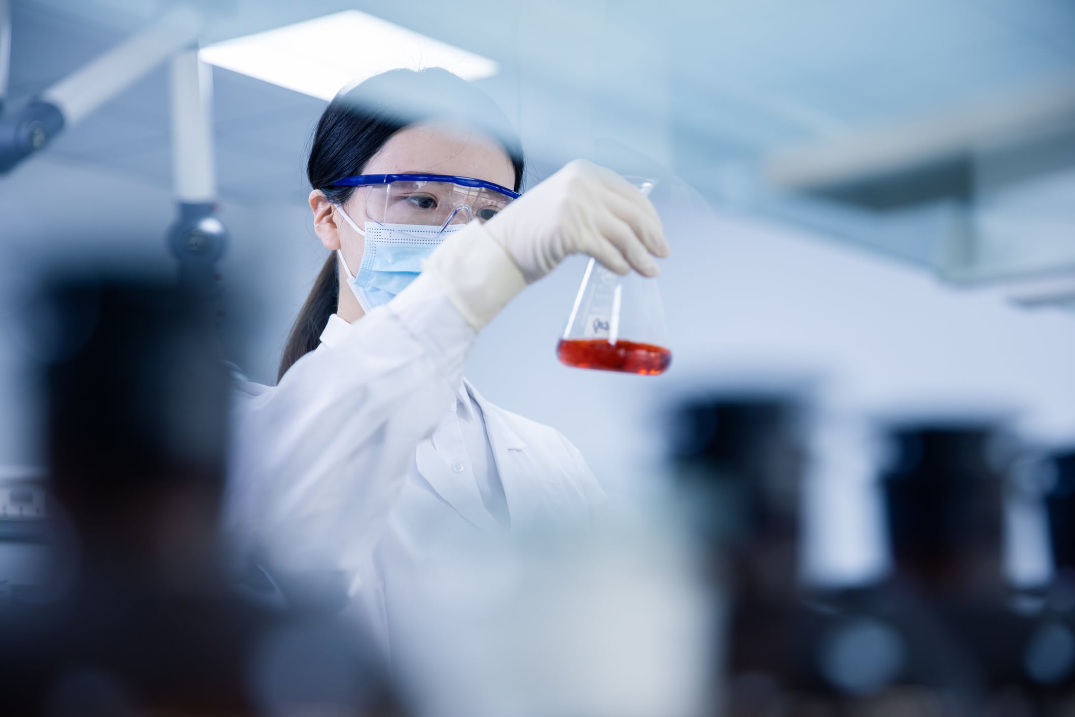 Asian female Scientist Working In Laboratory