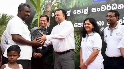 Officials present a plantlet to a local farmer