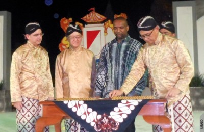 The US ambassador, in national dress, preparing to sign the agreement