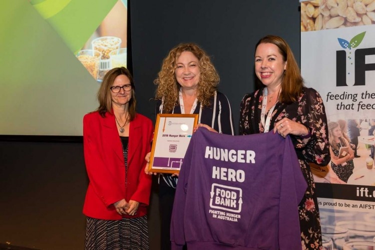 Foodbank Australia CEO Brianna Casey (far right) with the recipient of the inaugural AIFST Hunger Hero Award at the 2018 AIFST Convention in Melbourne, Australia.