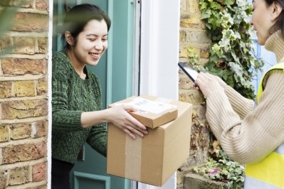 A woman receiving her online purchase from the courier. ©Getty Images 